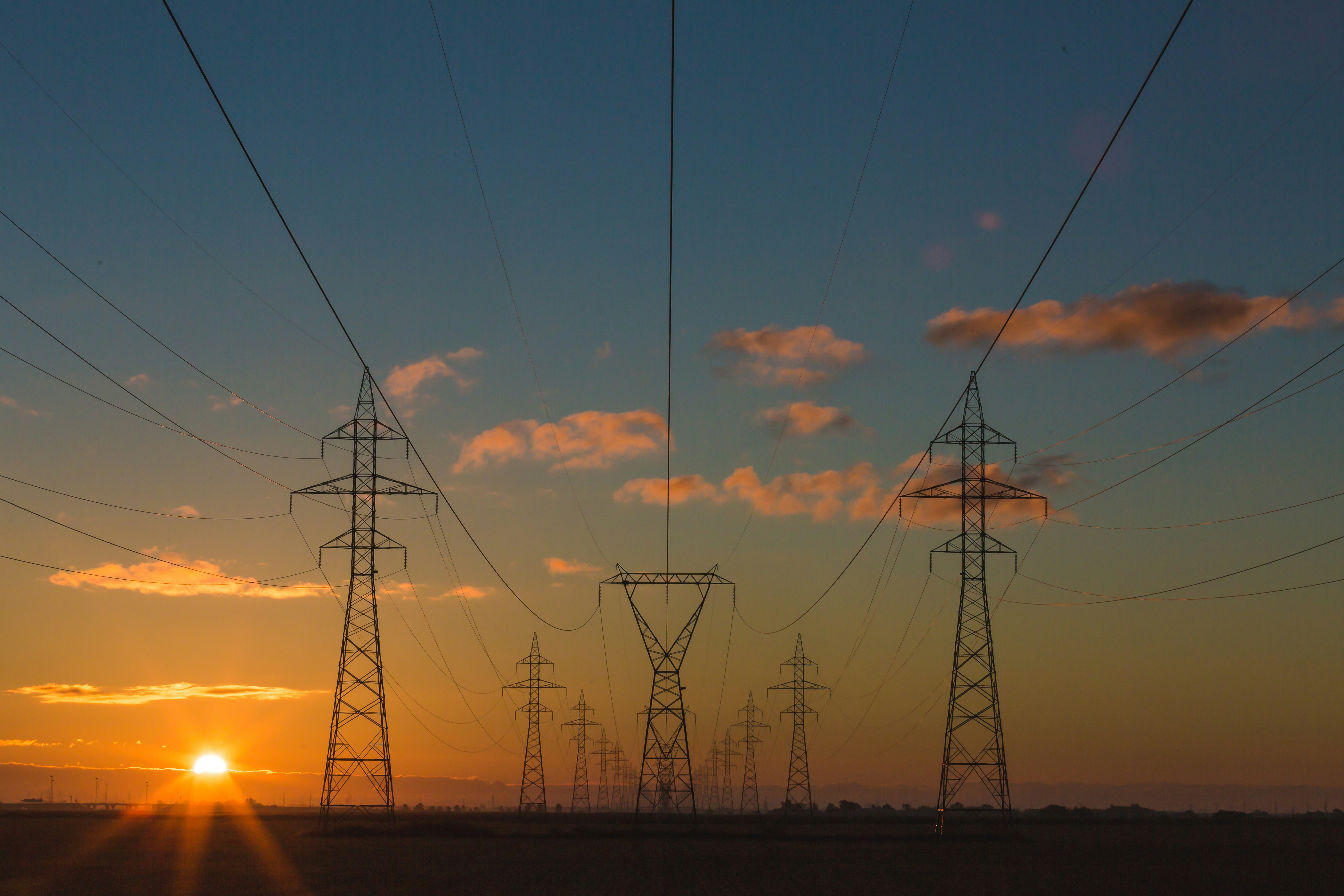Electricity transmission pylons at sunset